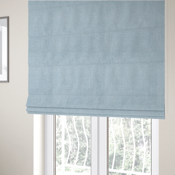 the fabric used to create these Roman blinds is a fine, woven upholstery fabric in a soft, airy, powder blue tone, featuring a consistent and textured surface pattern.