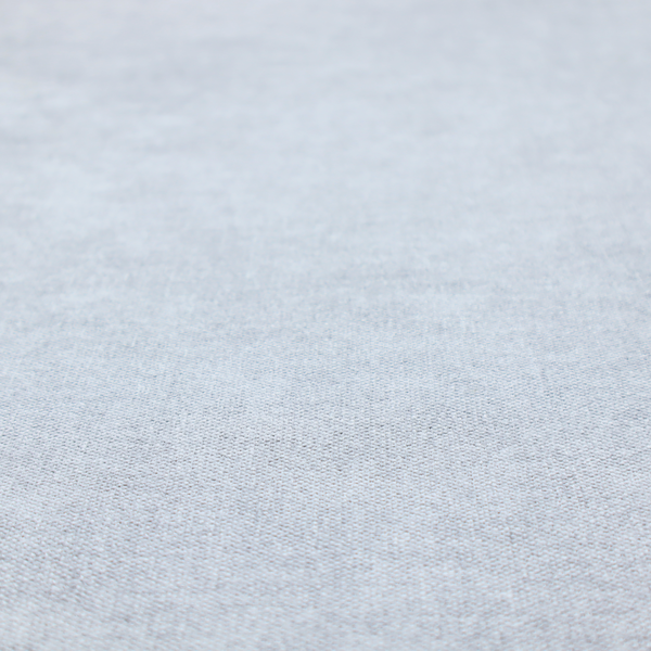 A fine, woven upholstery fabric in a subtle, cool-toned pale grey or off-white, featuring a consistent and textured surface pattern.