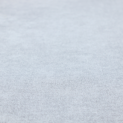 A fine, woven upholstery fabric in a subtle, cool-toned pale grey or off-white, featuring a consistent and textured surface pattern.