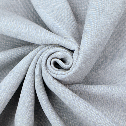 A fine, woven upholstery fabric in a subtle, cool-toned pale grey or off-white, featuring a consistent and textured surface pattern.
