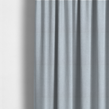 The fabric used to create these made-to-measure curtains is a fine, woven upholstery fabric in a subtle, cool-toned pale grey or off-white, featuring a consistent and textured surface pattern.