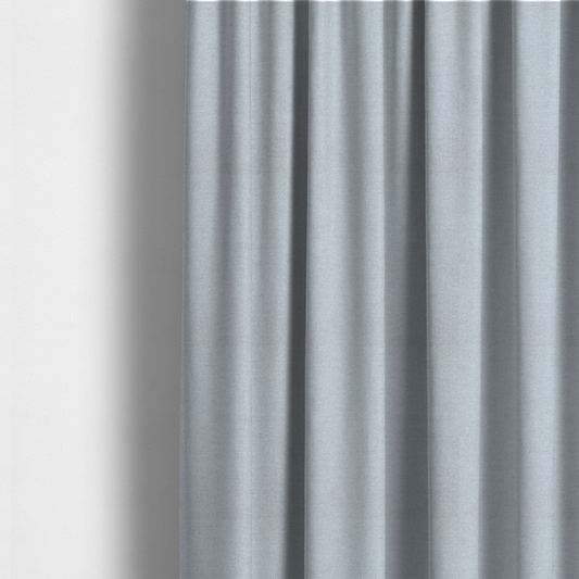 The fabric used to create these made-to-measure curtains is a fine, woven upholstery fabric in a subtle, cool-toned pale grey or off-white, featuring a consistent and textured surface pattern.