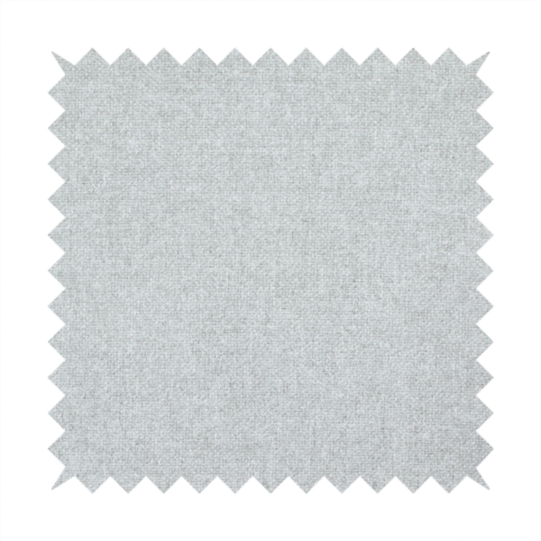 A fine, woven upholstery fabric in a clean, neutral light grey or soft silver tone, featuring a consistent and textured surface pattern.