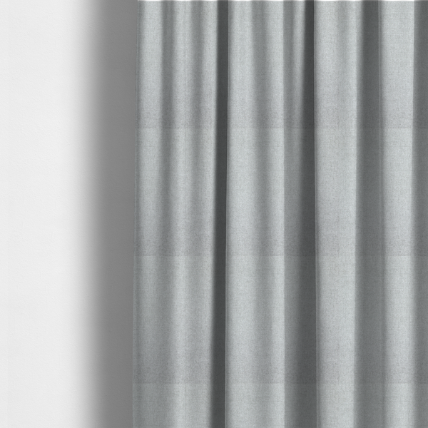 the fabric used to create these made-to-measure curtains is a fine, woven upholstery fabric in a clean, neutral light grey or soft silver tone, featuring a consistent and textured surface pattern.