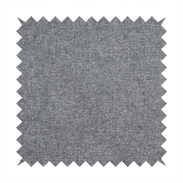 A fine, woven upholstery fabric in a deep, moody charcoal grey tone, featuring a consistent and textured surface pattern.