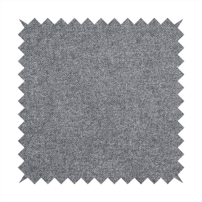 A fine, woven upholstery fabric in a deep, moody charcoal grey tone, featuring a consistent and textured surface pattern.