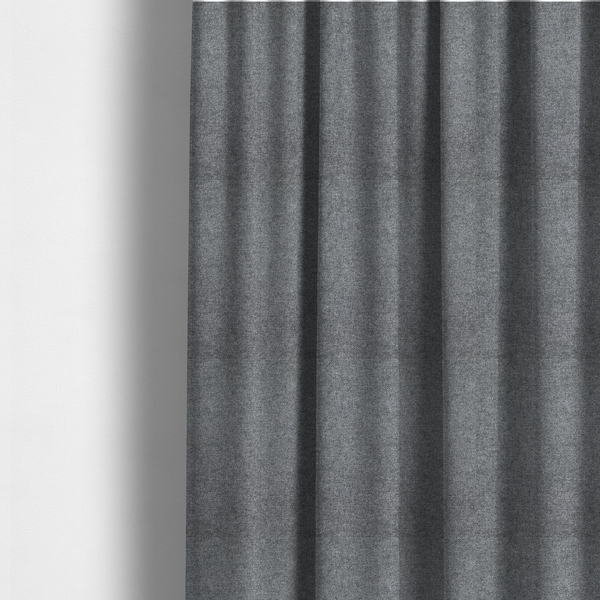 The fabric used to create these made-to-measure curtains is a fine, woven upholstery fabric in a deep, moody charcoal grey tone, featuring a consistent and textured surface pattern.