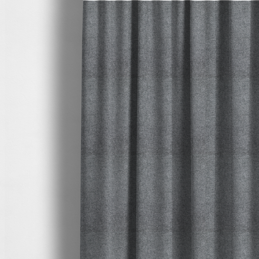The fabric used to create these made-to-measure curtains is a fine, woven upholstery fabric in a deep, moody charcoal grey tone, featuring a consistent and textured surface pattern.