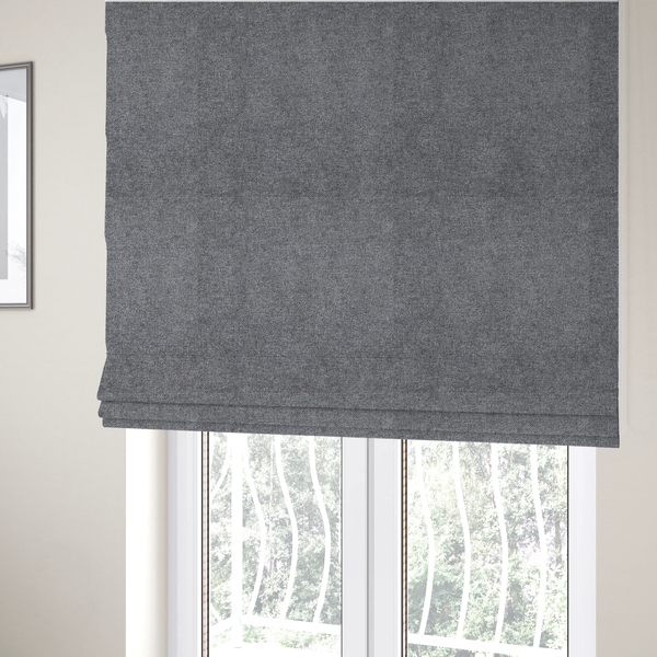 The fabric used to create these Roman blinds is a fine, woven upholstery fabric in a deep, moody charcoal grey tone, featuring a consistent and textured surface pattern.