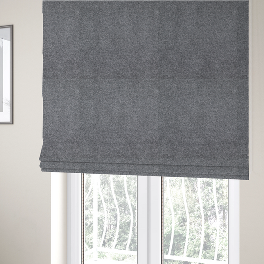 The fabric used to create these Roman blinds is a fine, woven upholstery fabric in a deep, moody charcoal grey tone, featuring a consistent and textured surface pattern.