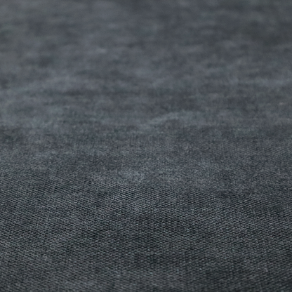 A fine, woven upholstery fabric in a dark, sophisticated slate grey or near-black tone, featuring a consistent and textured surface pattern.