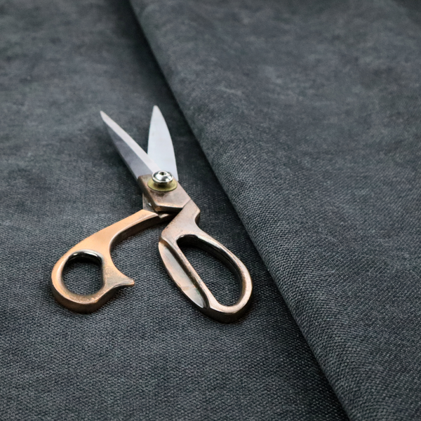 A fine, woven upholstery fabric in a dark, sophisticated slate grey or near-black tone, featuring a consistent and textured surface pattern.