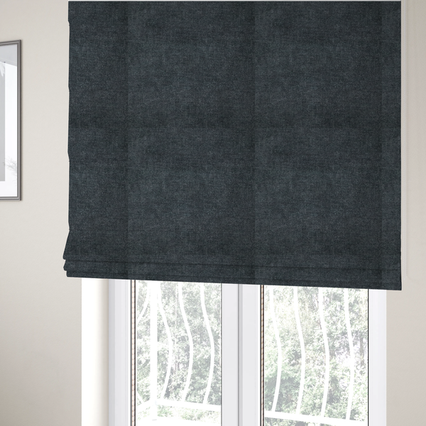 The fabric used to create these Roman blinds is a fine, woven upholstery fabric in a dark, sophisticated slate grey or near-black tone, featuring a consistent and textured surface pattern.