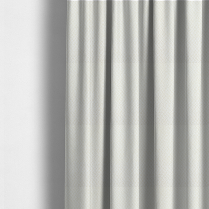 The fabric used to create these made-to-measure curtains is a cream or off-white fabric. The material features a dense, uniform, boucle-style weave, characterized by small, looped, and nubby yarn fibres that create a soft, textured surface appearance.