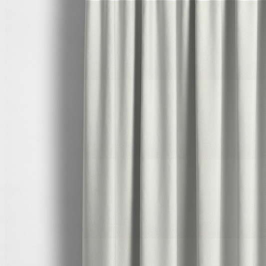 The fabric used to create these made-to-measure curtains is a cream or off-white fabric. The material features a dense, uniform, boucle-style weave, characterized by small, looped, and nubby yarn fibres that create a soft, textured surface appearance.