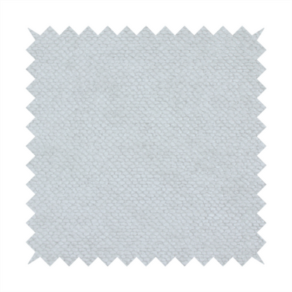 A cool-toned, light grey or silver upholstery fabric. It showcases the same dense, uniform, boucle-style weave seen in the previous image, consisting of small, looped, and nubby yarn fibres that create a soft, tactile surface.