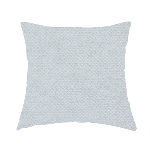 The fabric used to create this handmade cushion is a cool-toned, light grey or silver upholstery fabric. It showcases the same dense, uniform, boucle-style weave seen in the previous image, consisting of small, looped, and nubby yarn fibres that create a soft, tactile surface.