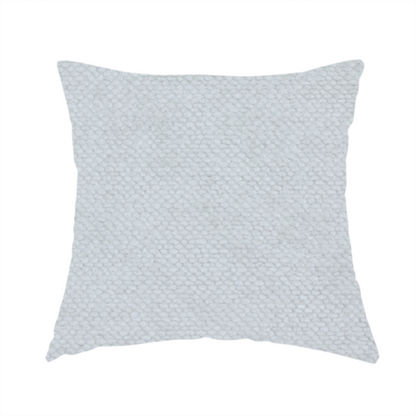 The fabric used to create this handmade cushion is a cool-toned, light grey or silver upholstery fabric. It showcases the same dense, uniform, boucle-style weave seen in the previous image, consisting of small, looped, and nubby yarn fibres that create a soft, tactile surface.