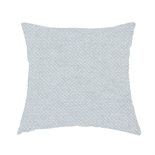 The fabric used to create this handmade cushion is a cool-toned, light grey or silver upholstery fabric. It showcases the same dense, uniform, boucle-style weave seen in the previous image, consisting of small, looped, and nubby yarn fibres that create a soft, tactile surface.