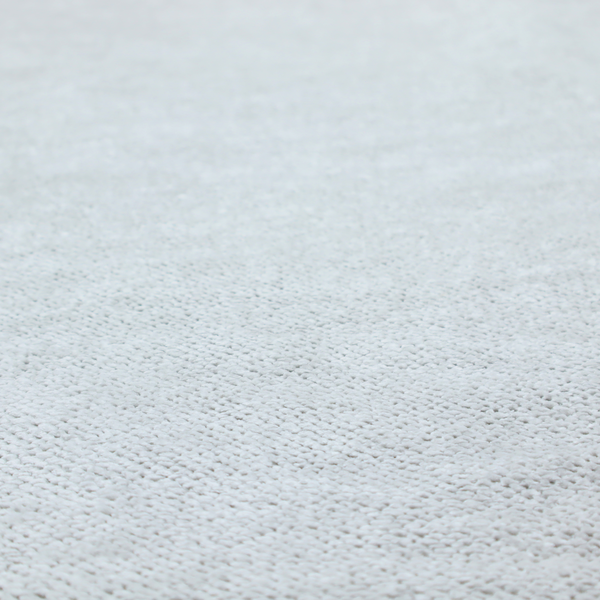 A cool-toned, light grey or silver upholstery fabric. It showcases the same dense, uniform, boucle-style weave seen in the previous image, consisting of small, looped, and nubby yarn fibres that create a soft, tactile surface.