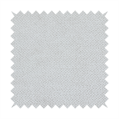 A light, neutral-toned upholstery fabric. It features the same signature dense, uniform, boucle-style weave as the previous samples, composed of small, looped, and nubby yarn fibres that provide a soft, tactile, and inviting surface.