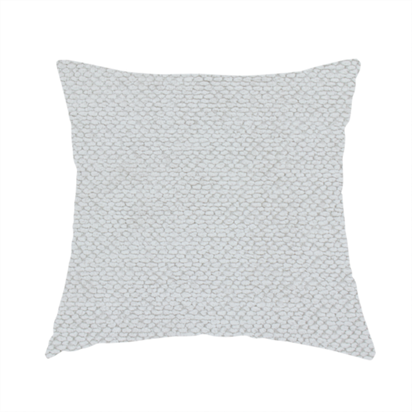 The fabric used to create this handmade cushion is a light, neutral-toned upholstery fabric. It features the same signature dense, uniform, boucle-style weave as the previous samples, composed of small, looped, and nubby yarn fibres that provide a soft, tactile, and inviting surface.