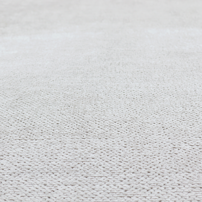 A light, neutral-toned upholstery fabric. It features the same signature dense, uniform, boucle-style weave as the previous samples, composed of small, looped, and nubby yarn fibres that provide a soft, tactile, and inviting surface.