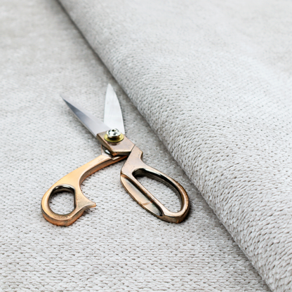 A light, neutral-toned upholstery fabric. It features the same signature dense, uniform, boucle-style weave as the previous samples, composed of small, looped, and nubby yarn fibres that provide a soft, tactile, and inviting surface.