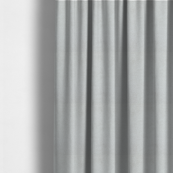 The fabric used to create these made-to-measure curtains is a light, neutral-toned upholstery fabric. It features the same signature dense, uniform, boucle-style weave as the previous samples, composed of small, looped, and nubby yarn fibres that provide a soft, tactile, and inviting surface.