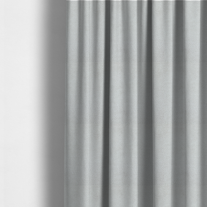 The fabric used to create these made-to-measure curtains is a light, neutral-toned upholstery fabric. It features the same signature dense, uniform, boucle-style weave as the previous samples, composed of small, looped, and nubby yarn fibres that provide a soft, tactile, and inviting surface.