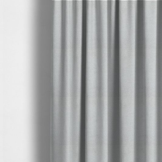 The fabric used to create these made-to-measure curtains is a light, neutral-toned upholstery fabric. It features the same signature dense, uniform, boucle-style weave as the previous samples, composed of small, looped, and nubby yarn fibres that provide a soft, tactile, and inviting surface.