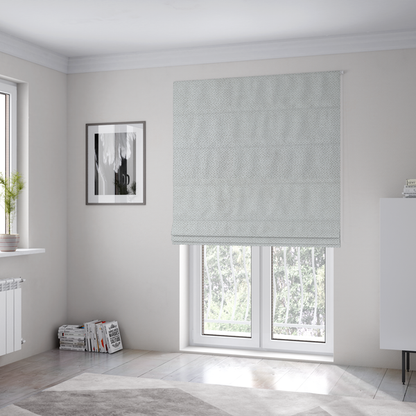 The fabric used to create these Roman blinds is a light, neutral-toned upholstery fabric. It features the same signature dense, uniform, boucle-style weave as the previous samples, composed of small, looped, and nubby yarn fibres that provide a soft, tactile, and inviting surface.