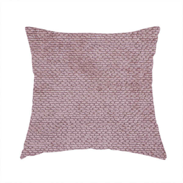 The fabric used to create this handmade cushion is a muted, dusty rose or soft mauve upholstery fabric. It maintains the signature dense, uniform, boucle-style weave seen in the previous samples, featuring small, looped, and nubby yarn fibres that create a soft and tactile surface.