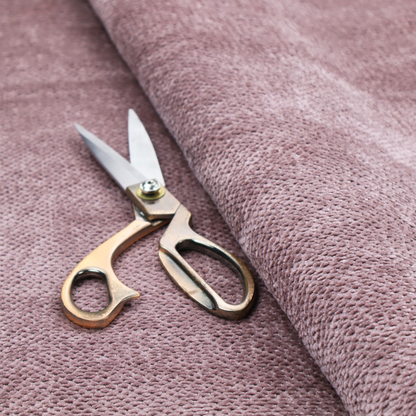 A muted, dusty rose or soft mauve upholstery fabric. It maintains the signature dense, uniform, boucle-style weave seen in the previous samples, featuring small, looped, and nubby yarn fibres that create a soft and tactile surface.