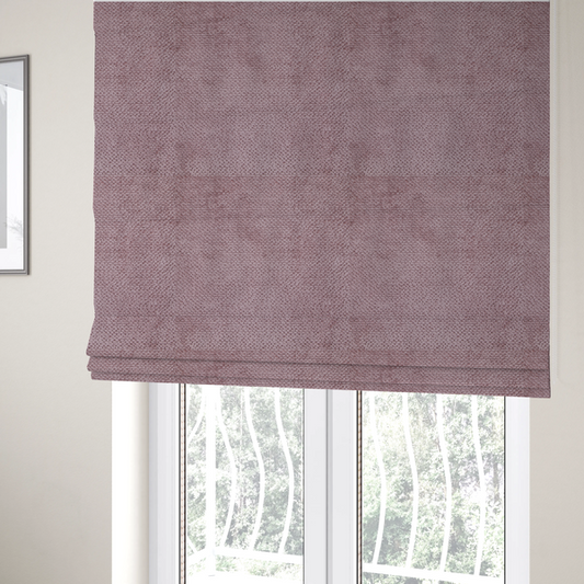 The fabric used to create these Roman blinds is a muted, dusty rose or soft mauve upholstery fabric. It maintains the signature dense, uniform, boucle-style weave seen in the previous samples, featuring small, looped, and nubby yarn fibres that create a soft and tactile surface.
