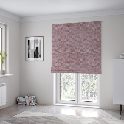 The fabric used to create these Roman blinds is a muted, dusty rose or soft mauve upholstery fabric. It maintains the signature dense, uniform, boucle-style weave seen in the previous samples, featuring small, looped, and nubby yarn fibres that create a soft and tactile surface.