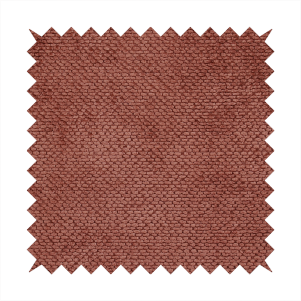 A rich, terracotta or rust-toned upholstery fabric. It maintains the signature dense, uniform, boucle-style weave featured in the collection, composed of small, looped, and nubby yarn fibres that provide a soft and tactile surface.