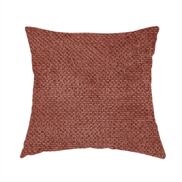 The fabric used to create this handmade cushion is a rich, terracotta or rust-toned upholstery fabric. It maintains the signature dense, uniform, boucle-style weave featured in the collection, composed of small, looped, and nubby yarn fibres that provide a soft and tactile surface.