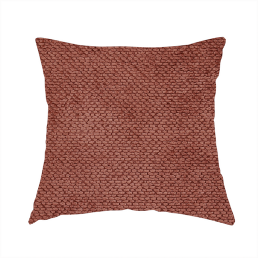 The fabric used to create this handmade cushion is a rich, terracotta or rust-toned upholstery fabric. It maintains the signature dense, uniform, boucle-style weave featured in the collection, composed of small, looped, and nubby yarn fibres that provide a soft and tactile surface.