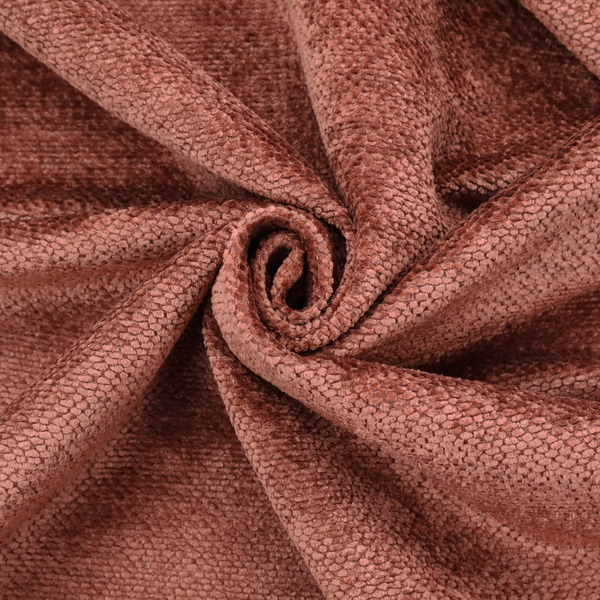 A rich, terracotta or rust-toned upholstery fabric. It maintains the signature dense, uniform, boucle-style weave featured in the collection, composed of small, looped, and nubby yarn fibres that provide a soft and tactile surface.