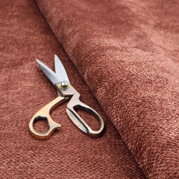 A rich, terracotta or rust-toned upholstery fabric. It maintains the signature dense, uniform, boucle-style weave featured in the collection, composed of small, looped, and nubby yarn fibres that provide a soft and tactile surface.