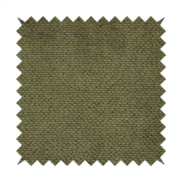 A deep, earth-toned olive green upholstery fabric. It continues the signature dense, uniform, boucle-style weave of the collection, created with small, looped, and nubby yarn fibres that offer a soft and tactile surface.