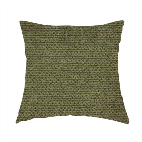 The fabric used to create this handmade cushion is a deep, earth-toned olive green upholstery fabric. It continues the signature dense, uniform, boucle-style weave of the collection, created with small, looped, and nubby yarn fibres that offer a soft and tactile surface.