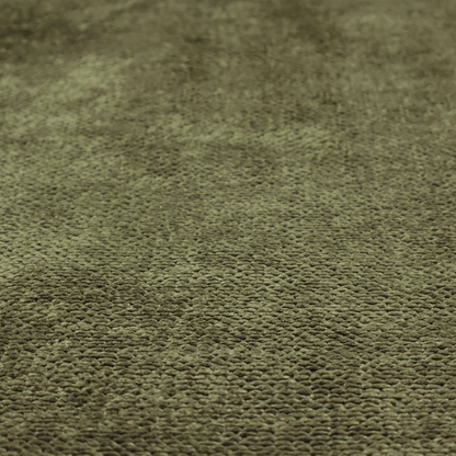 A deep, earth-toned olive green upholstery fabric. It continues the signature dense, uniform, boucle-style weave of the collection, created with small, looped, and nubby yarn fibres that offer a soft and tactile surface.