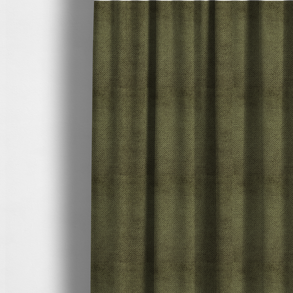 The fabric used to create these made-to-measure curtains is a deep, earth-toned olive green upholstery fabric. It continues the signature dense, uniform, boucle-style weave of the collection, created with small, looped, and nubby yarn fibres that offer a soft and tactile surface.