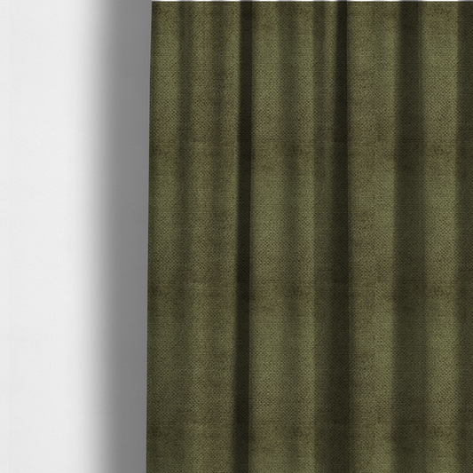 The fabric used to create these made-to-measure curtains is a deep, earth-toned olive green upholstery fabric. It continues the signature dense, uniform, boucle-style weave of the collection, created with small, looped, and nubby yarn fibres that offer a soft and tactile surface.
