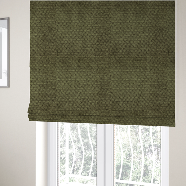 The fabric used to create these Roman blinds is a deep, earth-toned olive green upholstery fabric. It continues the signature dense, uniform, boucle-style weave of the collection, created with small, looped, and nubby yarn fibres that offer a soft and tactile surface.