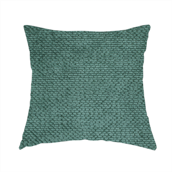 The fabric used to create this handmade cushion is a deep, rich teal or blue-green upholstery fabric. It maintains the signature dense, uniform, boucle-style weave of the collection, composed of small, looped, and nubby yarn fibres that create a soft and tactile surface.