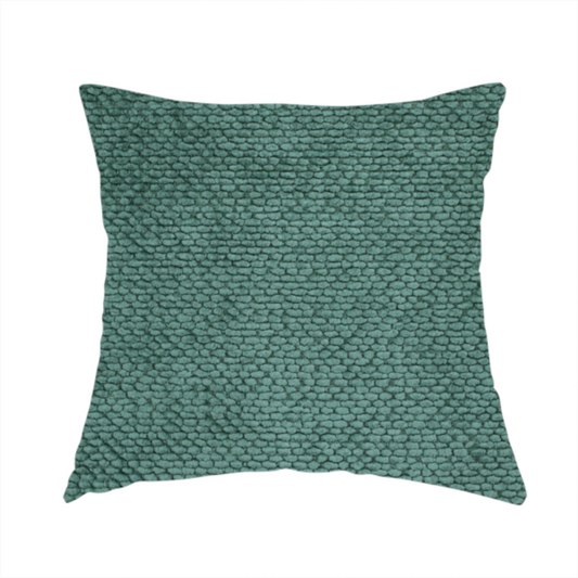 The fabric used to create this handmade cushion is a deep, rich teal or blue-green upholstery fabric. It maintains the signature dense, uniform, boucle-style weave of the collection, composed of small, looped, and nubby yarn fibres that create a soft and tactile surface.
