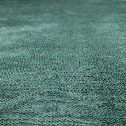 A deep, rich teal or blue-green upholstery fabric. It maintains the signature dense, uniform, boucle-style weave of the collection, composed of small, looped, and nubby yarn fibres that create a soft and tactile surface.